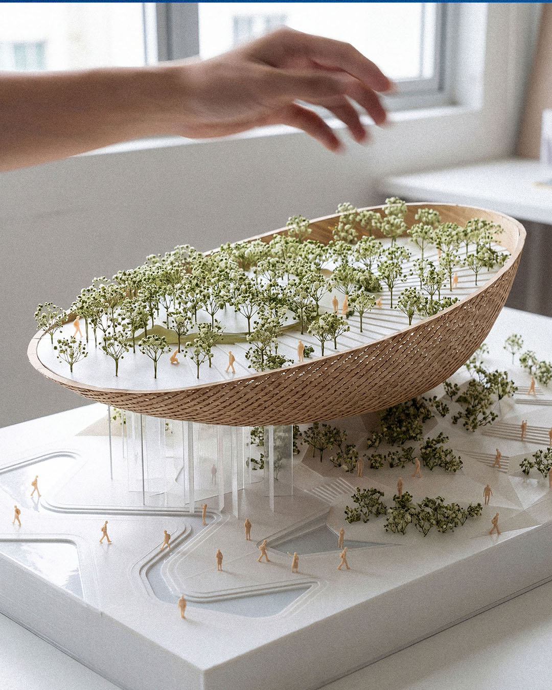 An architectural scale model of the exhibition pavilion featuring a woven timber vessel structure with a rooftop forest garden for the Malaysia Pavilion Concept, Osaka World Expo 2025.